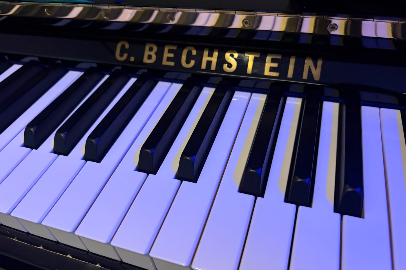 The keyboard and gold nameboard of the C. Bechstein A 124 piano in the studio